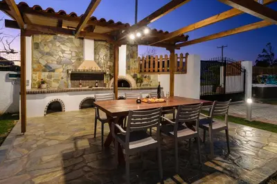a wooden table and chairs on a patio at Villa Albion in Kolymvari