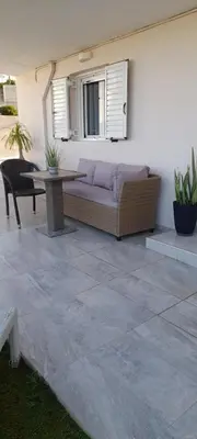 a couch and a table on a patio at Sunrise Apartment 2 in Souda