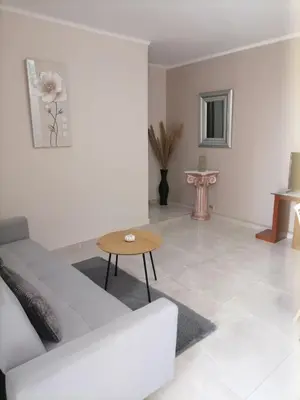 a living room with a white couch and a table at Sunrise Apartment 2 in Souda