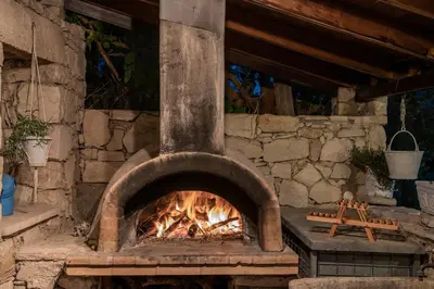 a brick oven with a fire inside of it at Villa Kritiko Archontiko in Koprána