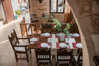 a dining room table and chairs with a table and chairs at Villa Kritiko Archontiko in Koprána