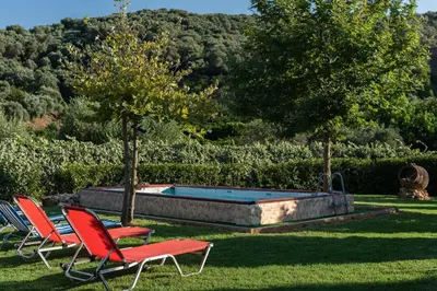 two chairs and a swimming pool in a yard at Villa Kalaitsidi - plunge pool, gym and unique gardens in Skinés