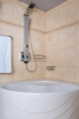 a bath tub in a bathroom with a shower at Villa Kalaitsidi - plunge pool, gym and unique gardens in Skinés