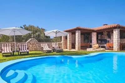 a swimming pool in the yard of a house at Villa Milon by PosarelliVillas in Skinés