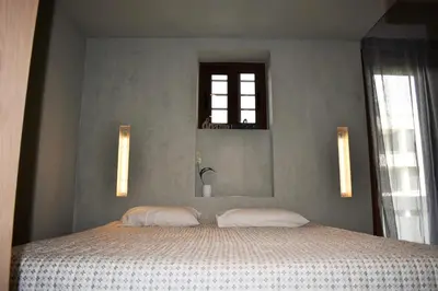a bedroom with a large bed with two pillows at Saxon's Apartment in Chania Town