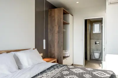 a bedroom with a bed and a bathroom at Seafront VILLA PELAGIA SUPERB New listing in Chania Town