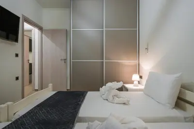 a bedroom with a bed with a stuffed animal on it at Cataleya Villa Chania in Daratso