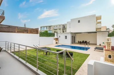 a view of the backyard from the balcony of a house at Cataleya Villa Chania in Daratso