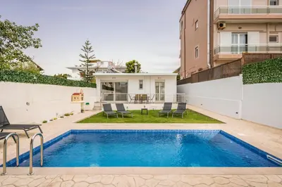 a swimming pool in the backyard of a house at Cataleya Villa Chania in Daratso