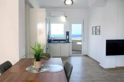 a dining room with a table with a plant on it at THALIA APARTMENTS CHANlA in Chania Town