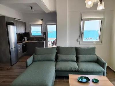 a living room with a couch and a table at THALIA APARTMENTS CHANlA in Chania Town