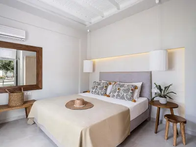 a bedroom with a bed with a hat on it at Anthos in Frangokastello