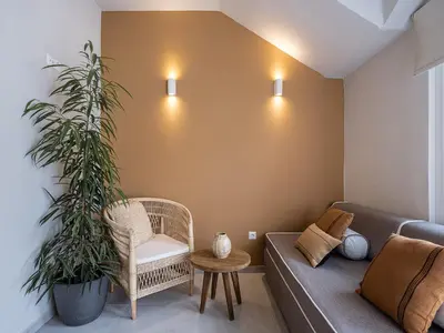 a living room with a couch and a plant at Anthos in Frangokastello