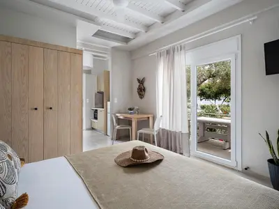 a bedroom with a bed with a hat on it at Anthos in Frangokastello