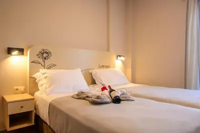 a hotel room with a bed with stuffed animals on it at Vakakis Family Luxury Studios in Palaiochóra