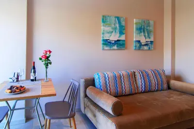 a living room with a couch and a table at Vakakis Family Luxury Studios in Palaiochóra