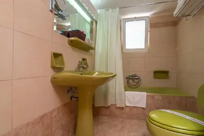 a bathroom with a yellow sink and a toilet at Hotel Elman in Palaiochóra
