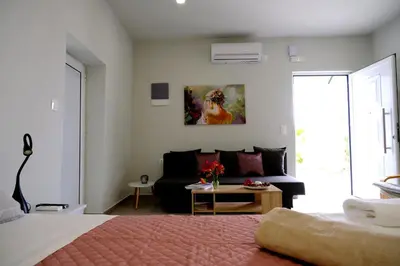 a living room with a bed and a couch at Erinaki Apartments in Kissamos