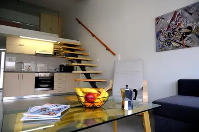 a living room with a glass table with a bowl of fruit at Erinaki Apartments in Kissamos