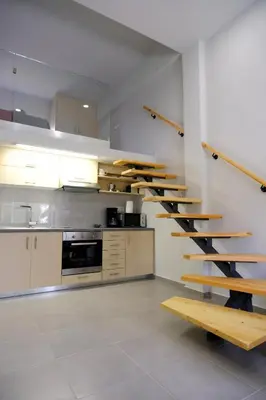 a kitchen with wooden stairs in a room at Erinaki Apartments in Kissamos