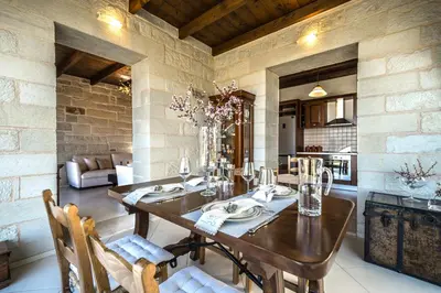 a dining room with a wooden table and chairs at FOS residence - ΦΩΣ ,luxury villa in Chania Town