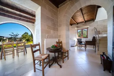 a living room with a table and chairs at FOS residence - ΦΩΣ ,luxury villa in Chania Town