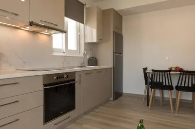 a kitchen with a sink and a stove top oven at Allview apartments in Palaiochóra