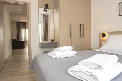 a bedroom with white towels stacked on a bed at Allview apartments in Palaiochóra