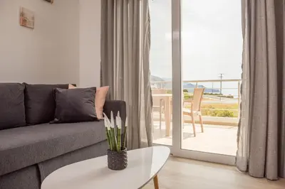 a living room with a couch and a table at Allview apartments in Palaiochóra