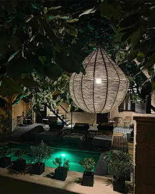 a large chandelier hanging from a ceiling with plants at Sclopa The Laography Project in Kolymvari