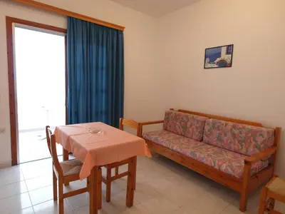 a living room with a couch and a table at Irini Apartments in Plataniás