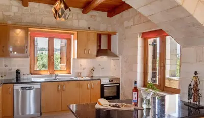 a kitchen with a sink and a stove top oven at World Villa in Tavronitis