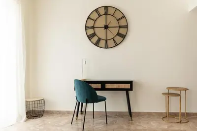 a room with a desk and a clock on the wall at Dream Casa by the Sea by 8essentially in Chania Town