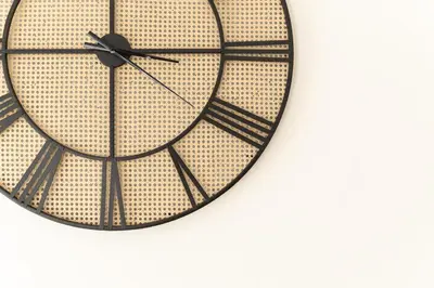 a large black and gold clock on a white background at Dream Casa by the Sea by 8essentially in Chania Town