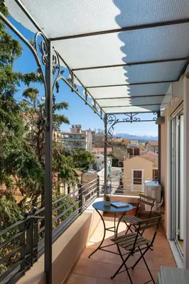 a patio with a table and chairs on a balcony at Orion Chania Boutique City House in Chania Town