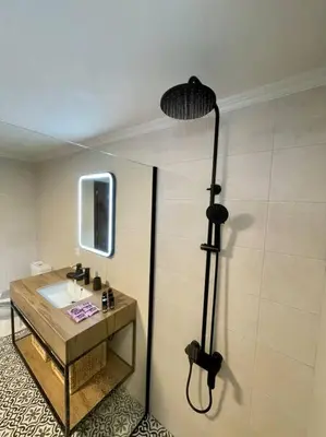 a bathroom with a shower and a sink at Villa Eftychia Serene Getaway with Hot Tub in a Quiet Location in Kissamos