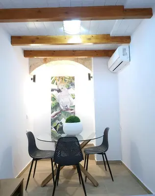 a dining room with a glass table and chairs at Mariviky design apartment in Chania Town