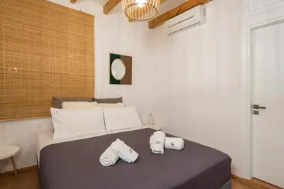 a bedroom with a bed with three towels on it at Mariviky design apartment in Chania Town