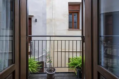 an open door to a balcony with plants at Mariviky design apartment in Chania Town