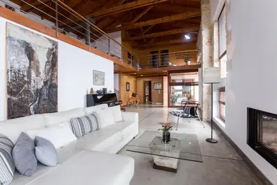 a living room with a white couch and a fireplace at Villa Yasemi panoramic sea view in Chania Town