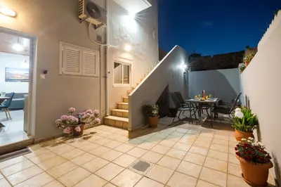 a house with a staircase and a table and chairs at Chrysa House Kissamos in Kissamos