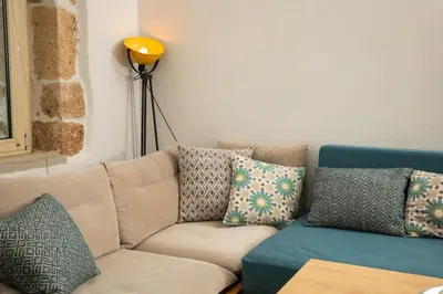 a living room with a couch with pillows at Mansion D in Galatás
