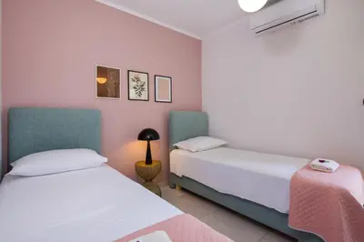 two beds in a room with pink and white at Anastasia & Maria Luxury Residence in Kissamos