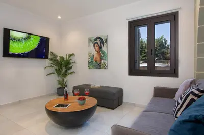 a living room with a couch and a table at Anastasia & Maria Luxury Residence in Kissamos