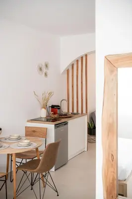 a kitchen and a dining room with a table at Astra boutique suites at Agia Marina Beach in Agia Marina Nea Kydonias