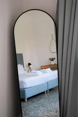 a bedroom with a bed and a mirror at MV Living - Residence in Chania Town