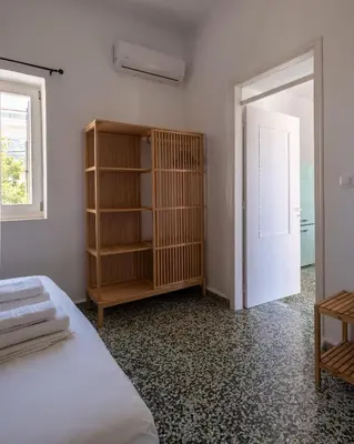 a bedroom with a bed and a book shelf at MV Living - Residence in Chania Town