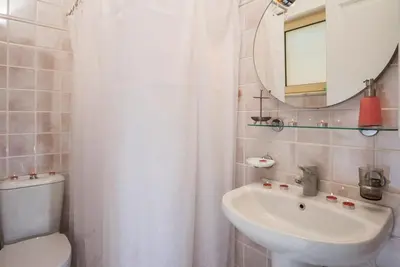 a bathroom with a sink and a toilet and a mirror at Seaview Villa Sofia ' Top destination ' in Kissamos