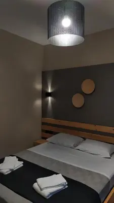 a bedroom with a large bed with a light above it at GioDriana cozy studio in Agia Marina Nea Kydonias