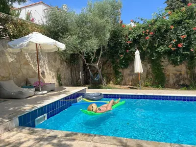 a woman laying on a raft in a swimming pool at Retreat Homes Apokoronas in Douliana